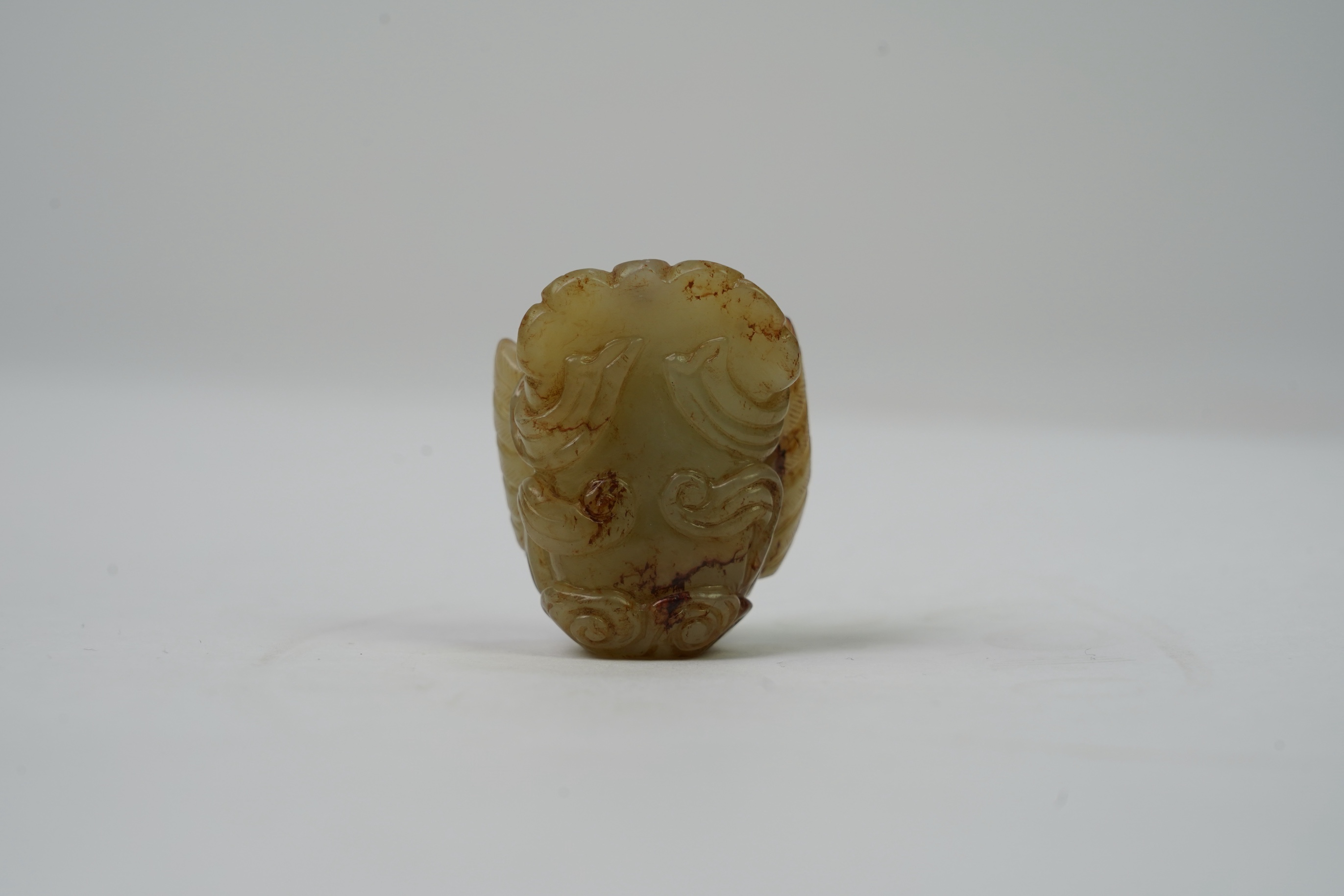 A Chinese archaistic celadon and russet jade figure a winged female immortal bird